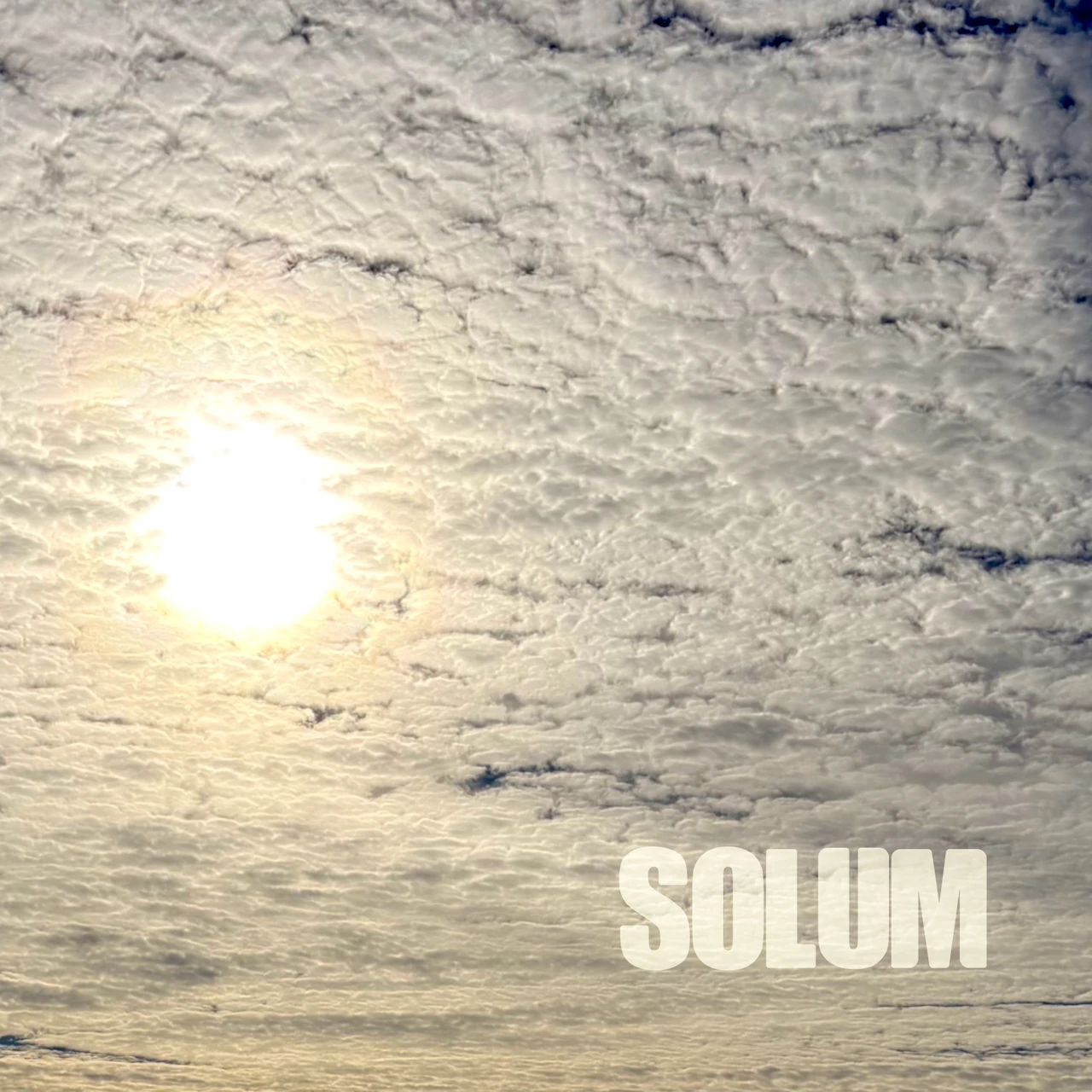 Solum album artwork: sunlight through clouds with the album title
